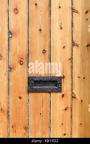 Old rustic cottage striped wooden door with metal letterbox Stock Photo