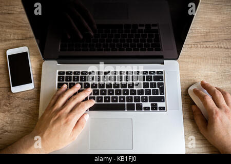 Male hands working on laptop, top view Stock Photo