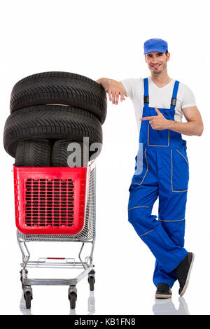 young  mechanic shopping  new tires, isolated over white Stock Photo
