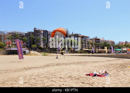 Paraglider landing in a special zone at Cleopatra Beach in Alanya (Turkey). Stock Photo
