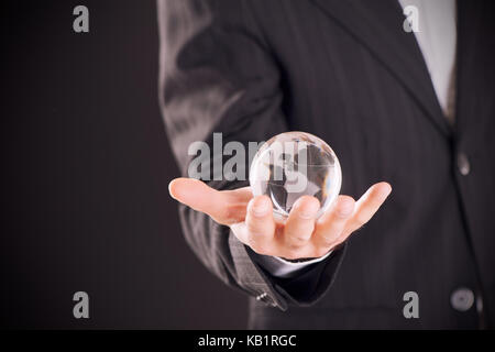 holding a glowing earth globe in hand Stock Photo