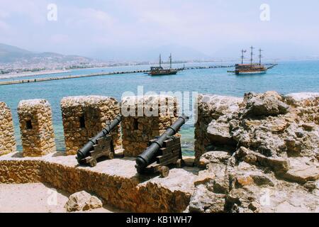 Medieval cannons and the fortress wall of Alanya Castle (Alanya, Turkey). Stock Photo