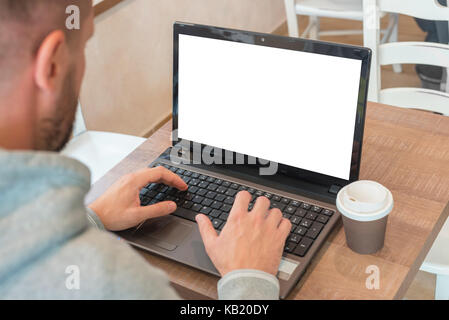 Man work on laptop computer with isolated blank screen for web site presentation mockup. Stock Photo