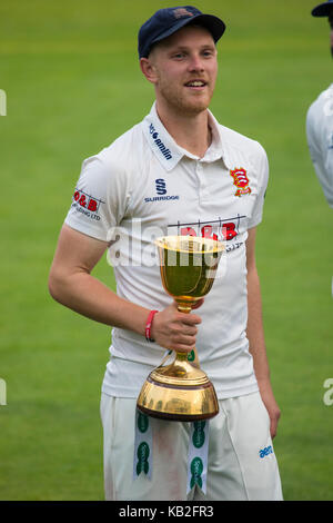 ESSEX, UK - SEPTEMBER 27TH 2017: Leading wicket-taker Jamie Porter with the Specsavers County Championship Division One Trophy at the County Ground. Stock Photo