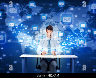 Smiling man with futuristic digital tablet, global communication with mail Stock Photo