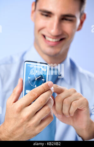 Young man with transparent futuristic phone, concept actual future innovative ideas and best technologies humanity. Stock Photo