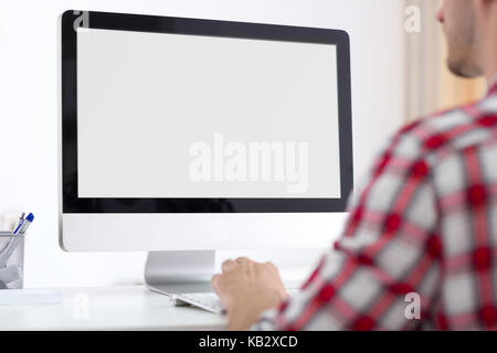 Person front of empty computer monitor, back view Stock Photo
