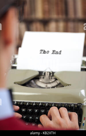 writer typing the end title on the typewriter Stock Photo