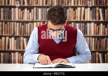 learning in library,  focused student reading book Stock Photo