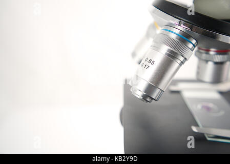 Close up of the lenses of a microscope on white background, Scientific concept for presentation template. Scientific or medical instrument Stock Photo