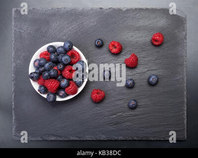 Close Up Of Raspberries Scattered On White Boards Stock Photo - Alamy