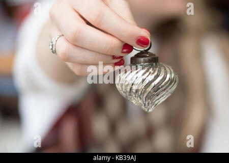 woman holding rustic authentic vintage glass holiday christmas ornaments Stock Photo