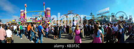 Oktoberfest in Munich, extreme panoramic photo of the guests and amusement rides, Stock Photo