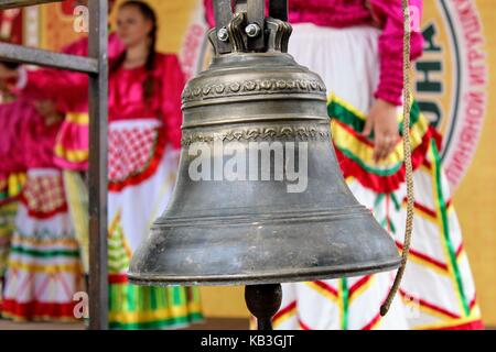 June, 2017, Odoev (Russia): Folk Festival 'Grandfather Filimon's Tales' - a bronze bell on the stage. Stock Photo