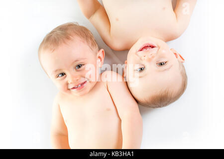 Twin brother having fun on a studio white floor Stock Photo