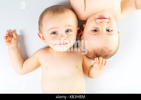 Twin brother having fun on a studio white floor Stock Photo