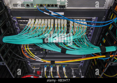 Structured cabling for fiberoptic networks and video in communications rack Stock Photo