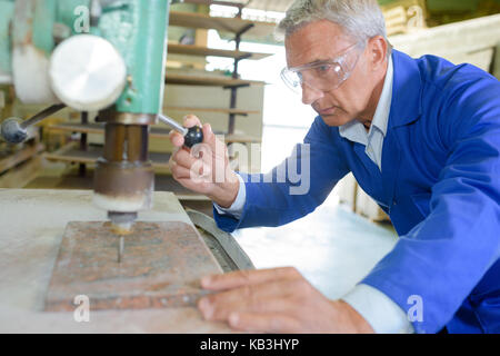 milling-machine operator works at machine Stock Photo