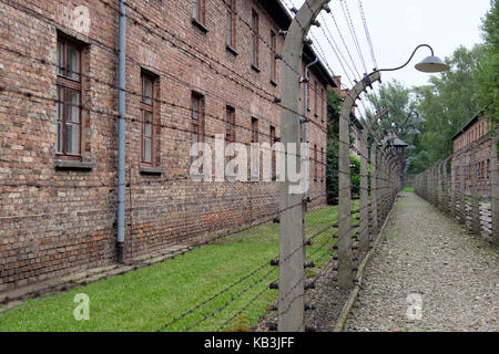 Barracks behind barbed wire frences at Auschwitz WWII Nazi concentration camp, Poland Stock Photo