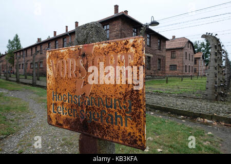 Warning sign for electric fence at the Auschwitz WWII Nazi concentration camp, Poland Stock Photo