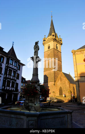 France, Bas Rhin, Obernai, market square, the chapel tower, Sainte Odile fountain and the town hall Stock Photo