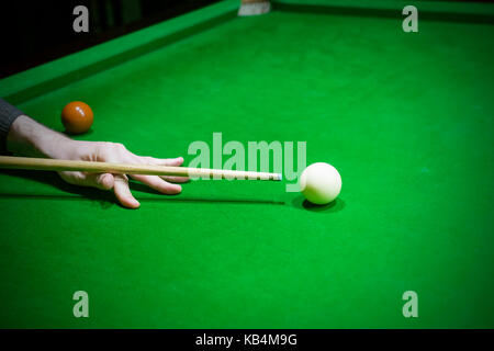 Snooker table. Player aiming the cue ball. Stock Photo