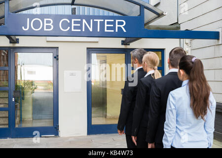 Group Of Businesspeople Standing In Row Outside The Job Center Stock Photo