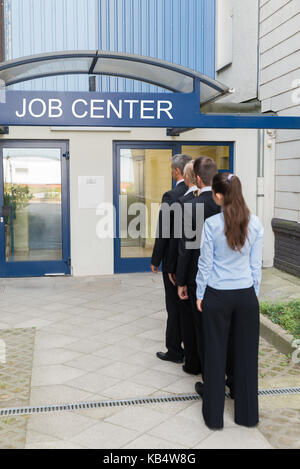 Group Of Businesspeople Standing In Row Outside The Job Center Stock Photo