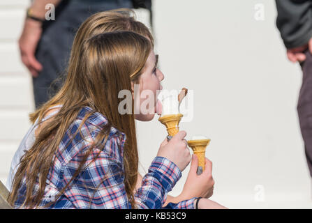 Young girl eating a 99 ice cream cone on a hot day in the UK. Stock Photo