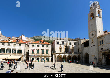 Croatia, Dalmatia, Dalmatian coast, Dubrovnik historical centre, listed as World Heritage by UNESCO, Luza square with Sponza Palace Clock Tower Stock Photo