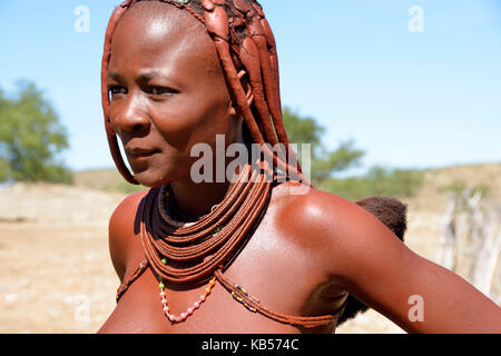 Namibia, Kaokoland or Kaokoveld, Himba village, young himba woman Stock Photo