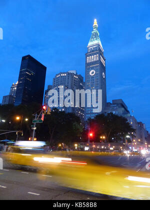 NYC, view of Fifth Avenue and 23rd Street intersection with passing yellow cabs with Madison Avenue office towers Stock Photo