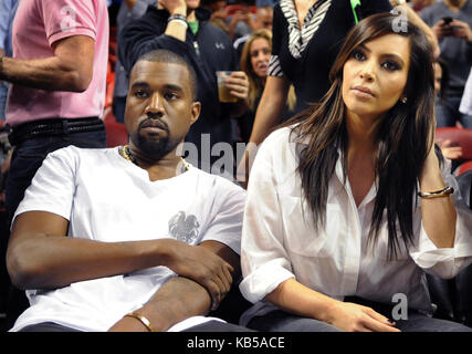 MIAMI, FL - DECEMBER 06: Kanye West and Kim Kardashian attend the game between the New York Knicks and Miami Heat at American Airlines Arena on December 6, 2012 in Miami, Florida.   Credit Hoo-Me.com / MediaPunch  People:  Kanye West Kim Kardashian  Transmission Ref:  FL77 Stock Photo