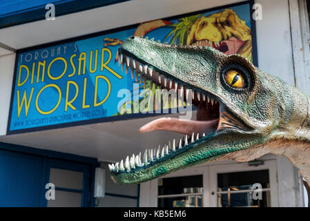 Large Dinosaur and sign outside Dinosaur World Torquay, Devon UK. A scary but educational tourist attraction on the Harbourside. Children and adults Stock Photo