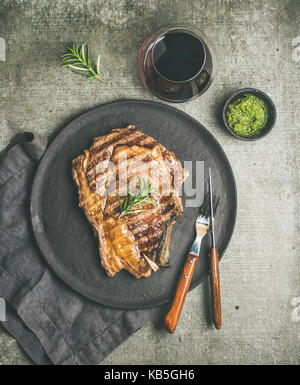 Flat-lay of Grilled hot rib-eye beef steak on bone Stock Photo