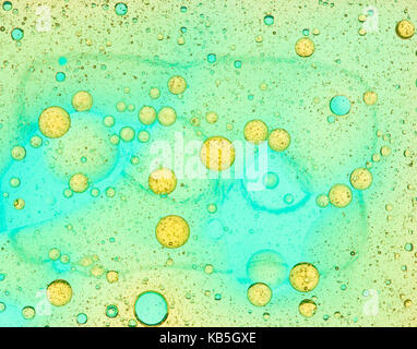 yellow oil bubbles on blue background Stock Photo