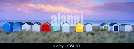 Colourful beach huts and sand dunes at sunset, Southwold, Suffolk, England, United Kingdom, Europe Stock Photo