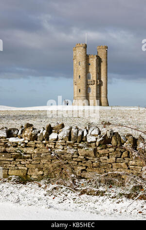 Broadway Tower and Cotswold drystone wall in snow, Broadway, Cotswolds, Worcestershire, England, United Kingdom, Europe Stock Photo