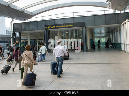 Passengers walk through the South Terminal entrance at Gatwick Stock Photo