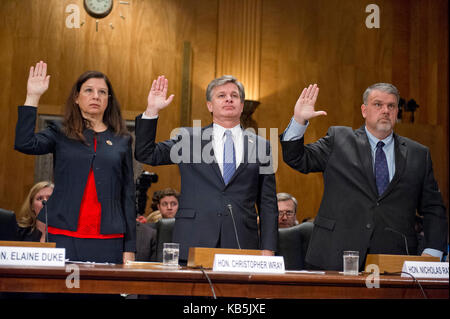 From left to right: Acting United States Secretary of Homeland Security Elaine C. Duke; Christopher A. Wray Director, Federal Bureau of Investigation (FBI); and Nicholas J. Rasmussen, Director, National Counterterrorism Center, Office of the Director of National Intelligence, are sworn-in to testify before the United States Senate Committee Homeland Security and Governmental Affairs on 'Threats to the Homeland' on Capitol Hill in Washington, DC on Wednesday, September 27, 2017. Credit: Ron Sachs / CNP  - NO WIRE SERVICE - Photo: Ron Sachs/Consolidated/dpa Stock Photo