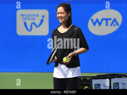 Wuhan, China. 28th Sep, 2017. Chinese two-time Grand Slam champion Li Na shows tennis skills to young players during the 2017 WTA Wuhan Open Project event in Wuhan, capital of central China's Hubei Province, on Sept. 28, 2017. Credit: Xinhua/Alamy Live News Stock Photo