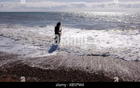 Brighton, UK. 28th Sep, 2017. A musician plays a saxophone in the sea on Hove beach during a beautiful hot sunny day on the south coast of Britain Credit: Simon Dack/Alamy Live News Stock Photo