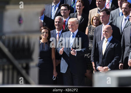 Washington, Us. 28th Sep, 2017. United States President Donald J. Trump poses for a group photo with a group of National Security Council staff members on the steps of the Eisenhower Executive Office Building in Washington, DC on Thursday, September 28, 2017. Pictured with the President are Dina Powell, Deputy National Security Advisor for Strategy, left, and H.R. McMaster, National Security Advisor, right. Credit: Alex Edelman/CNP - NO WIRE SERVICE - Credit: Alex Edelman/Consolidated/dpa/Alamy Live News Stock Photo