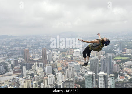 Kuala Lumpur, MALAYSIA. 29th Sep, 2017. Base jumpers leaps from the 300-metre high open deck at Kuala Lumpur Tower during the Kuala Lumpur Tower Jump 2017 on Friday, September 29 in Kuala Lumpur, Malaysia. 120 professional base jumpers from 24 countries.The event will take event from 30th September to 2nd October. Credit: ZUMA Press, Inc./Alamy Live News