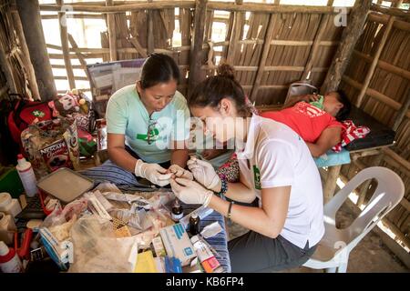 Mindoro is an island in the west of the Philippines. The indigenous peoples of the province are the Mangyans, they live off civilization areas and avoid contact with other islanders. Only the German Doctors come regularly and provide medical assistance. Ap | usage worldwide Stock Photo