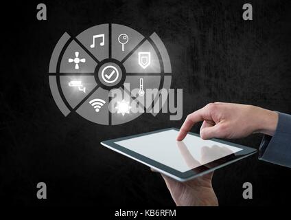 Digital composite of Hand holding tablet with icons interface of internet of things Stock Photo