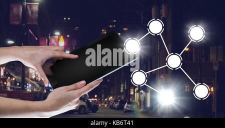 Digital composite of Hand holding tablet with icons interface of internet of things Stock Photo