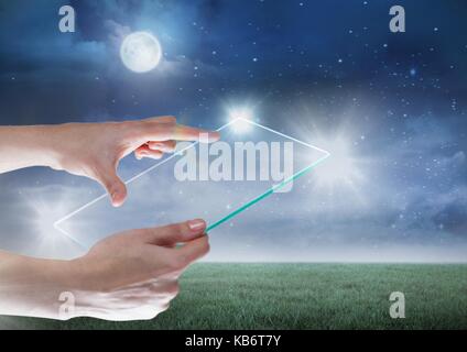 Digital composite of Hand holding glass tablet with glow and moon Stock Photo