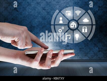 Digital composite of Hand holding phone with icons interface of internet of things Stock Photo