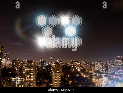 Digital composite of Icons interface of hexagons glowing over night city background Stock Photo